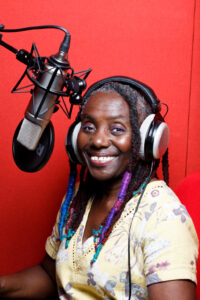 Cornelia Colman in a sound booth smiling